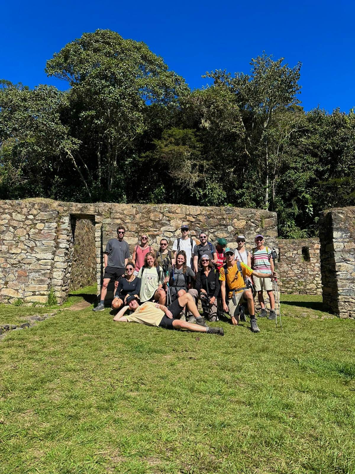 Konex retreat group gathered at stone ruins surrounded by forest