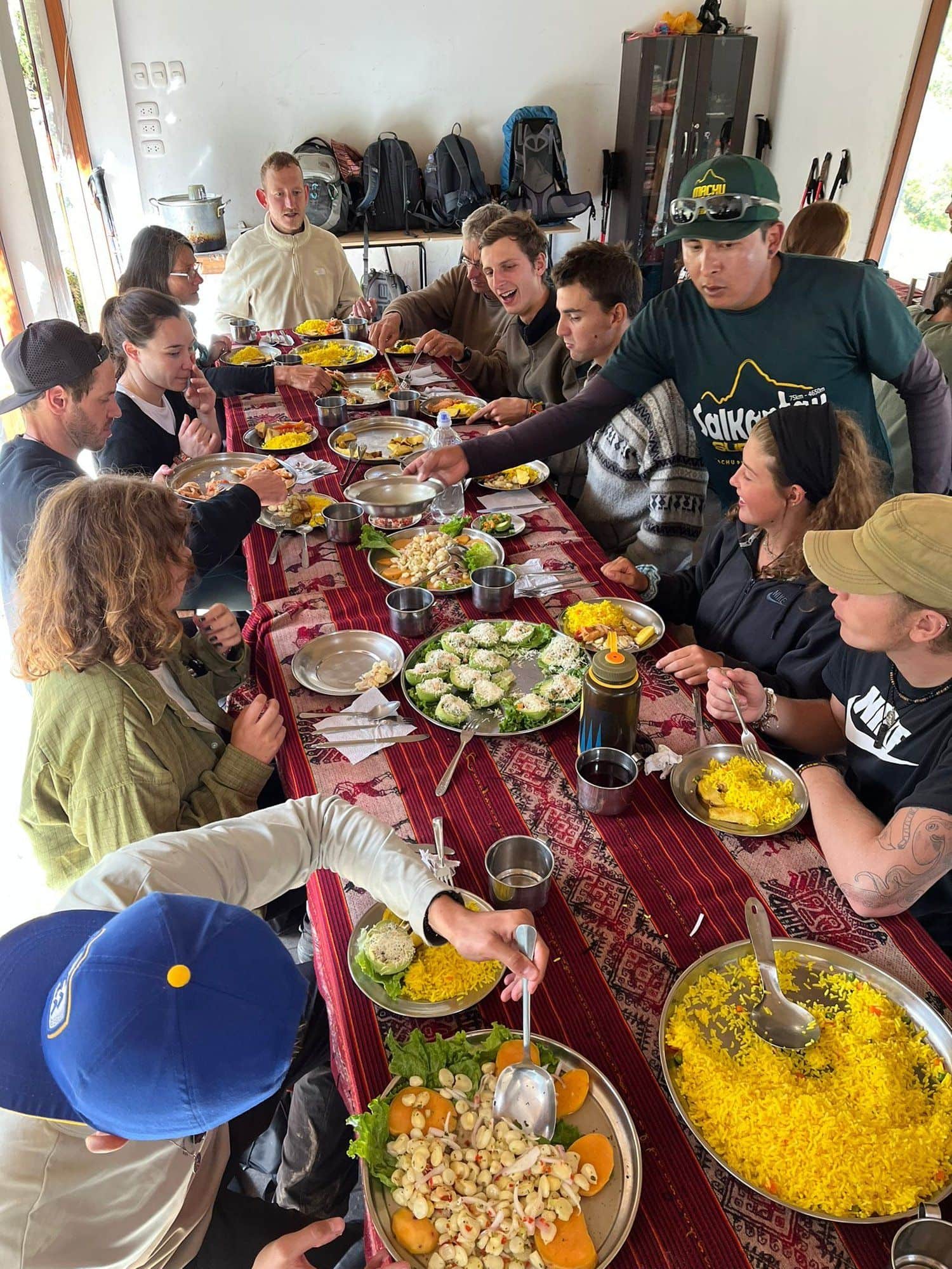 Konex retreat participants sharing a long communal meal after a day on the trail