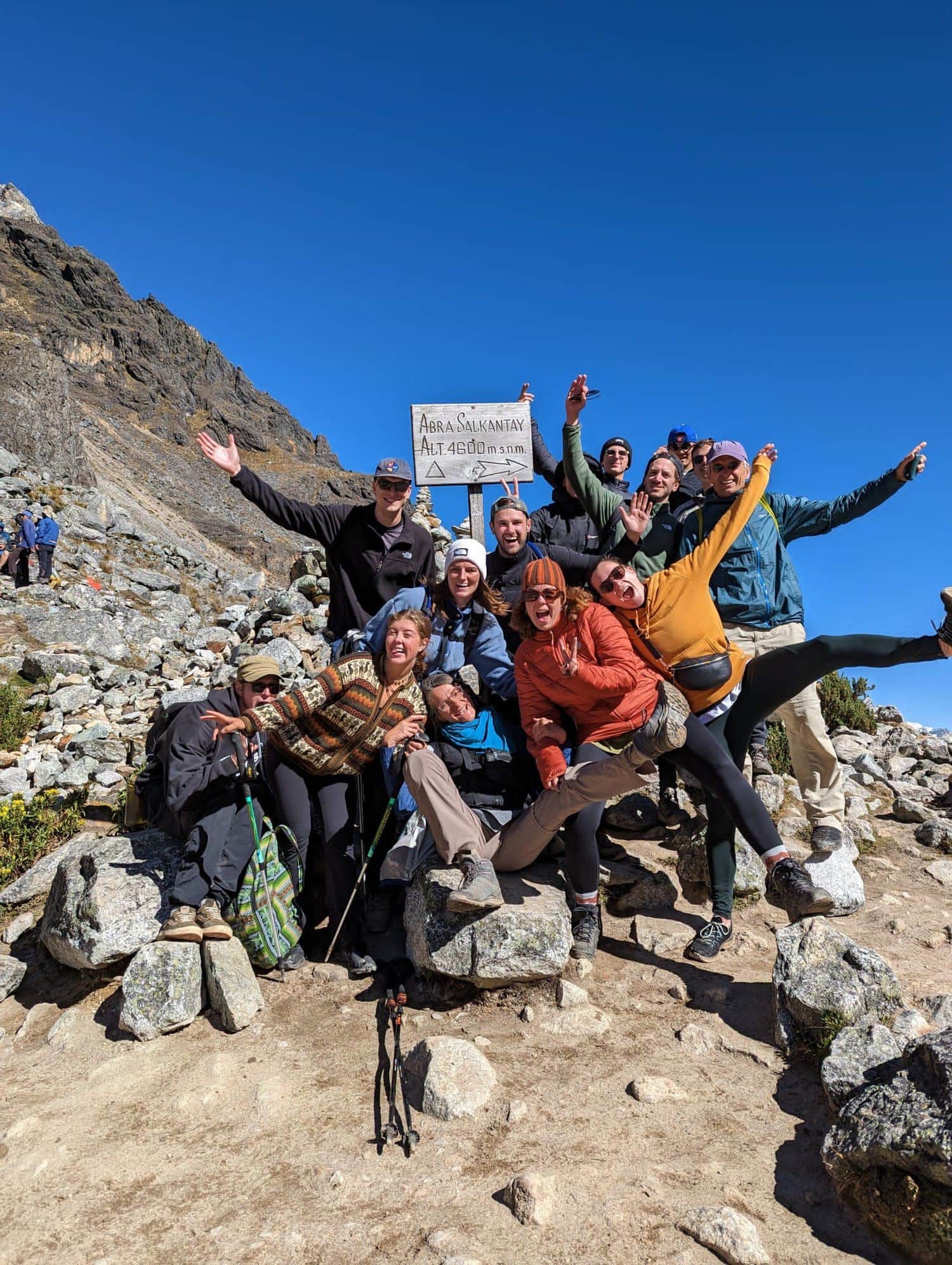 Konex group celebrating at a high mountain pass summit marker
